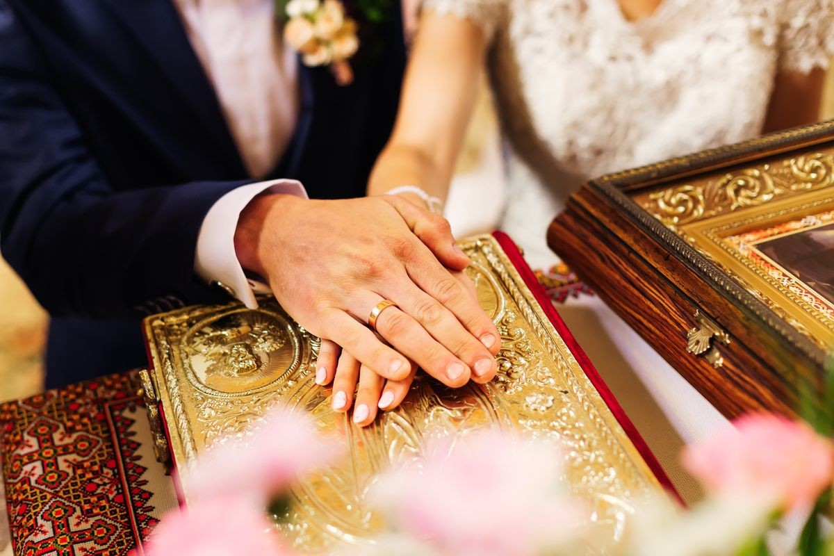 the newlyweds laid their hands with the wedding rings on the holy book and exchanged their vow