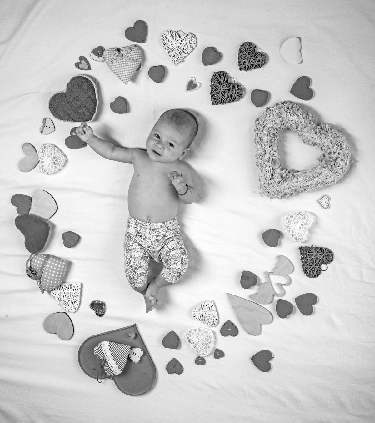 Pleasant timespending. Love. Portrait of happy little child. Sweet little baby. New life and birth. Family. Child care. Small girl among red hearts. Childhood happiness.Valentines day.